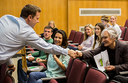 Image of Glenn Close seated in classroom among students and researchers